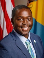 Headshot of Stephan Browne-Blackman, LGBTQ+ Commissioner, smiling in a blue suit.